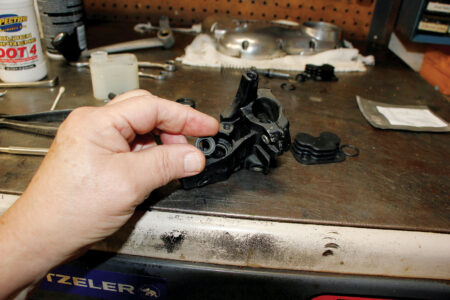 A hand holding the washer and seal